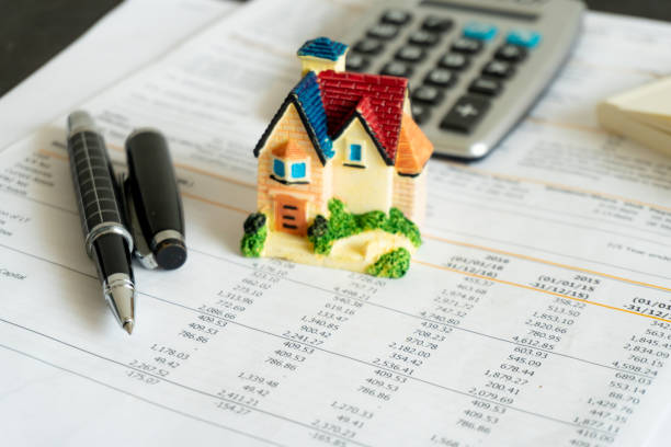 istock Home loan bank debit statement with house miniature 1311282431