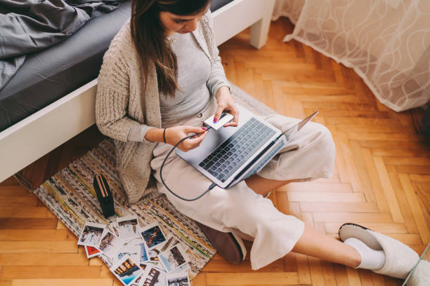istock Woman printing photos from her laptop 1311282554
