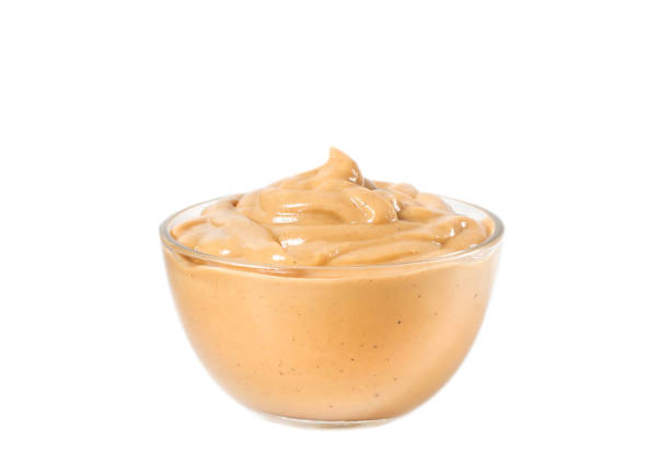 istock Mustard in a glass bowl close-up on a white background 1311285279