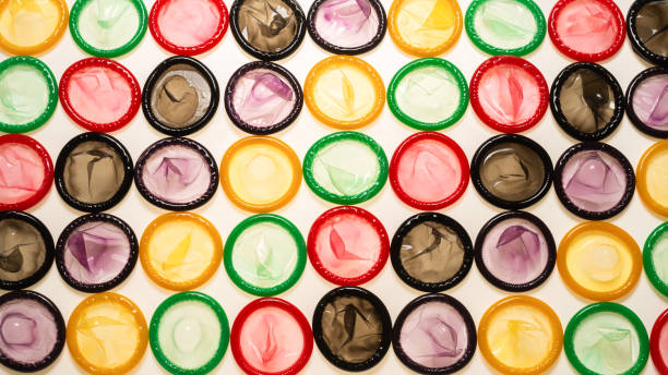istock Colorful condoms background. 1311286753