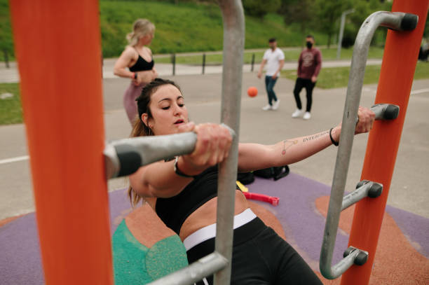 istock Young woman exercising in a cross training park 1311288021