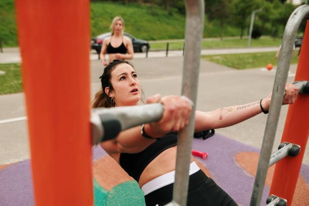istock Young woman exercising in a cross training park 1311288032