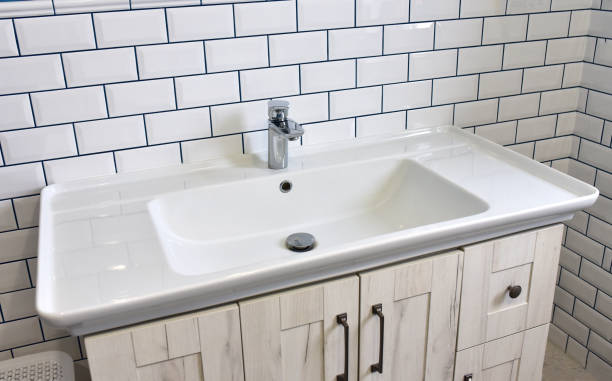 istock Modern bathroom Interior with design washbasin on a background of white ceramic tiles 1311289161