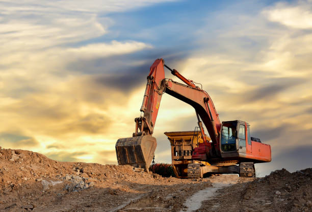 istock Mobile Stone Jaw crusher machine and excavator during crushing concrete on construction site 1311290341