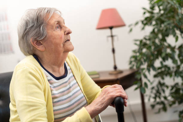 istock Elderly woman with her hands on a cane 1311291734