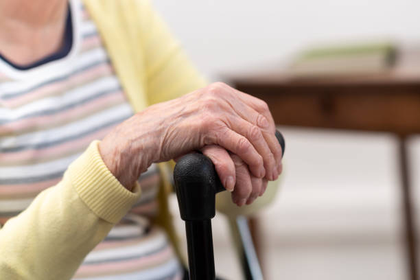 istock Old woman with her hands on a cane 1311291756
