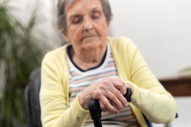 istock Old woman with her hands on a cane 1311292122