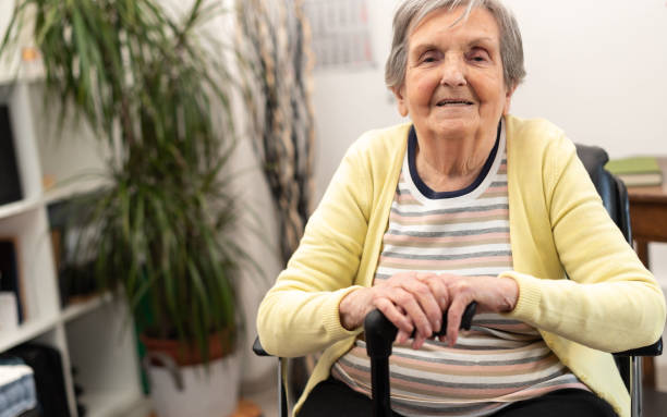 istock Elderly woman with her hands on a cane 1311292146