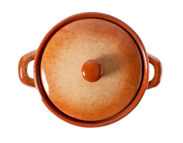 Brown clay pot with a closed lid on a white background, top view