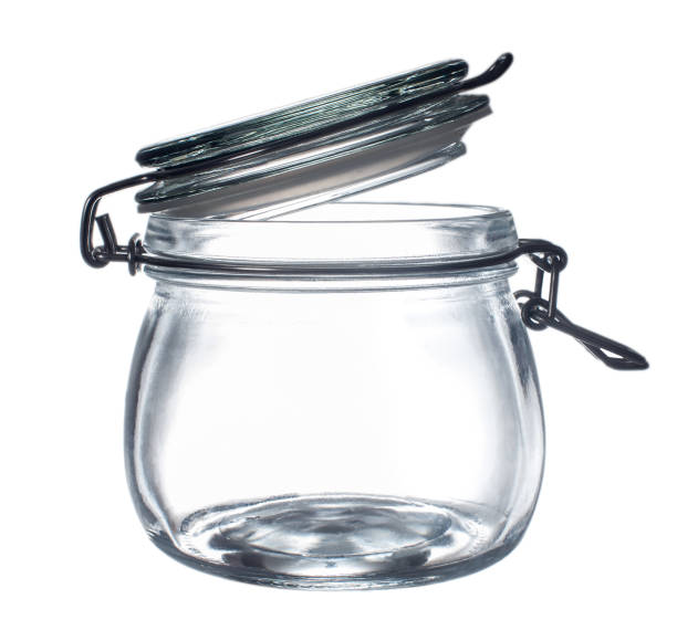 istock Empty glass jar with an open clamp cover on a white background close-up 1311295057