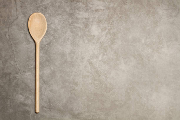 istock Wooden spoon with a long handle on a marble table 1311295087
