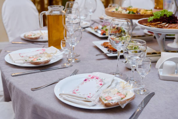 istock Table setting with sparkling wineglasses and cutlery on table, copy space. Menu mockup, place setting at wedding reception. Table served for wedding banquet in restaurant 1311296714