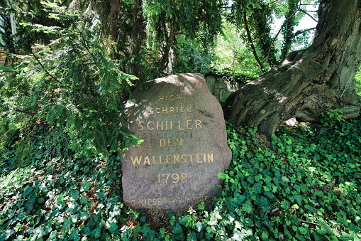 Looking at a small rock with an engraving in honor of Friedrich Schiller. It reads \