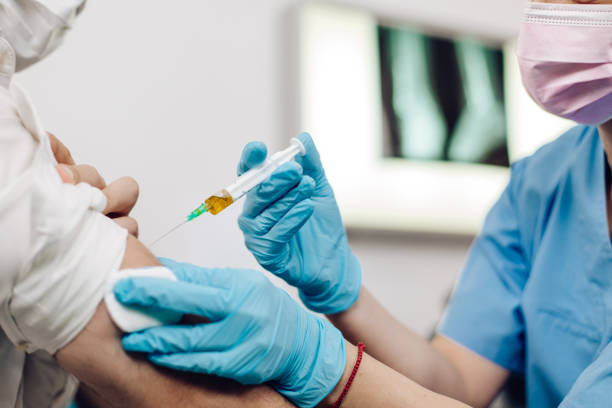 istock Doctor vaccinating the patient against Covid-19 1311297742