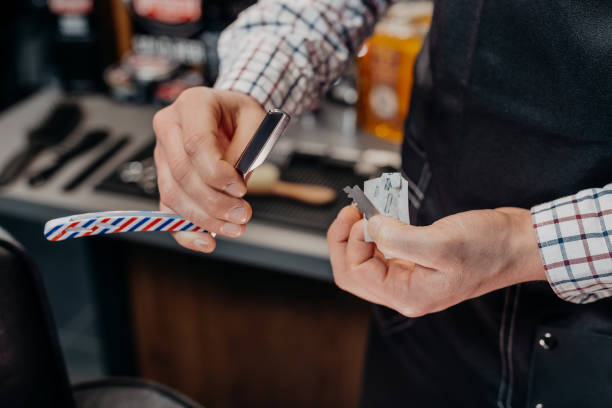 istock Barber holding razor. Barbershop equipment 1311297793