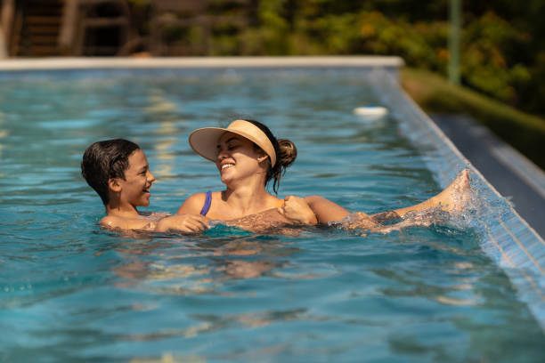 istock Mother and son bathing in the pool 1311298342