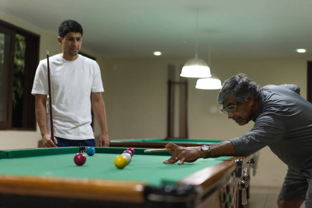 istock Father and son playing billiard in the game house 1311299599