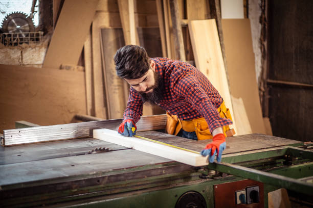 istock Young man at carpentry cutting wood with a circular saw 1311301114