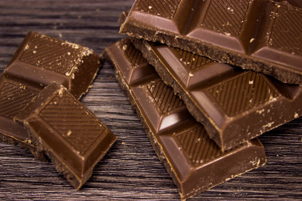 istock Chocolate Bars on wooden table top view 1311301155