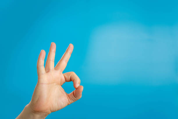 istock hand ok sign on blue background 1311302229