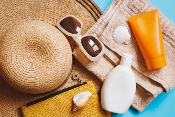 istock Flat lay summer travel photography. View from above beach essentials. Straw hat, moisturizing sunscreen for sensitive skin and body lotion, sunglasses and cosmetic bag 1311302558