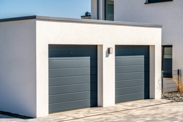 istock Modern double garage with sectional doors as a secure parking space in your own house 1311303699