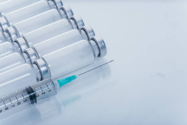 Medicine, Injection, vaccine and disposable syringe, drug concept. Sterile vial medical syringe needle. Glass medical ampoule vial for injection. stock photo