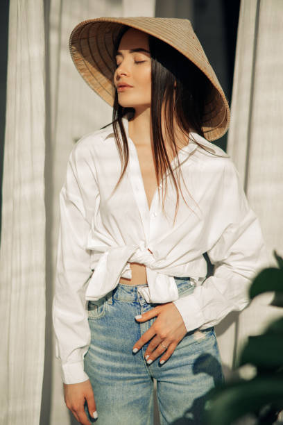 istock Young woman has a relax and stands in vietnamese hat. 1311306428