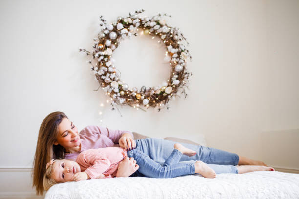 istock Mother plays with her daughter on the bed. 1311306723