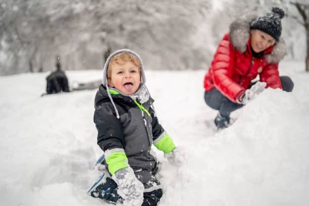 istock Mother and a son spending winter day outside on the snow 1311310892
