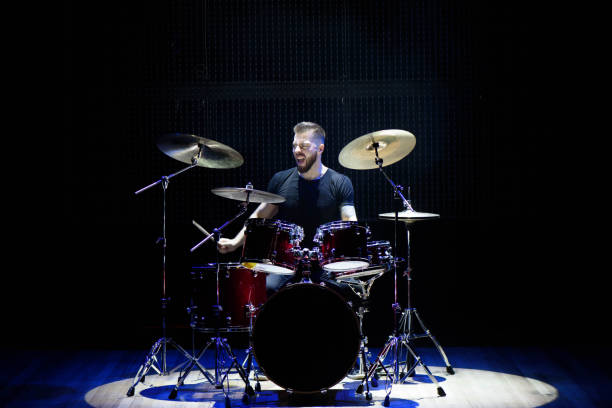 istock Silhouette drummer on stage. Dark background, smoke spotlights. 1311313013