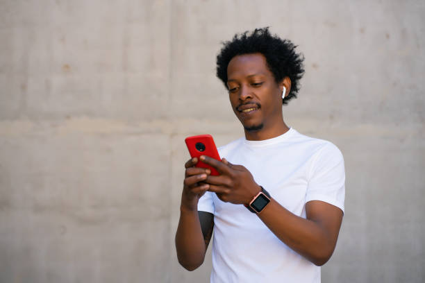 istock Athletic man using his mobile phone outdoors. 1311313670