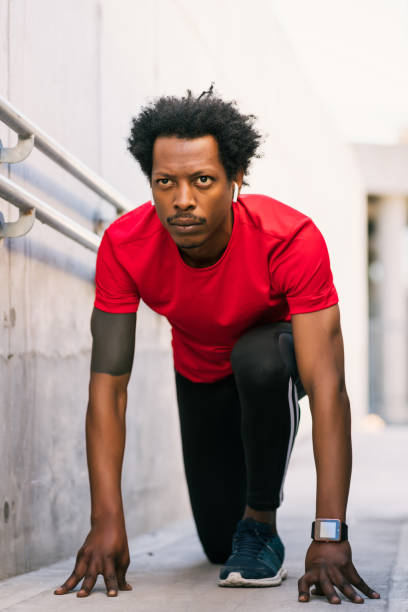 istock Athlete man in start position preparing to run outdoors. 1311313672
