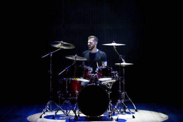 istock Silhouette drummer on stage. Dark background, smoke spotlights. 1311313768