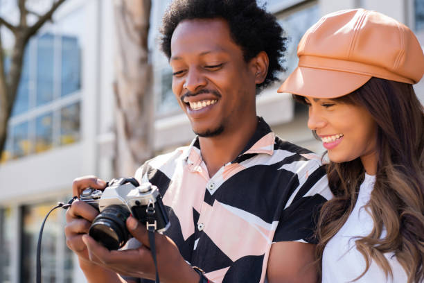 istock Tourist couple using camera outdoors. 1311313771