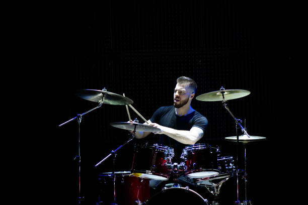 istock Silhouette drummer on stage. Dark background, smoke spotlights. 1311313773