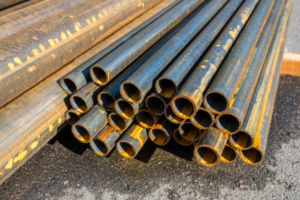 istock round metal pipes on asphalt, close-up 1311314699