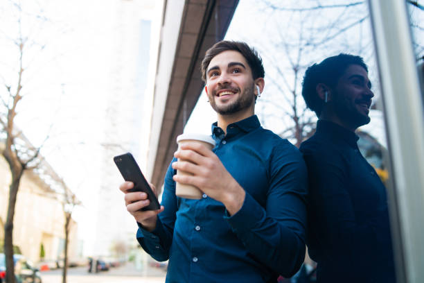 istock Young man using his mobile phone outdoors. 1311315083