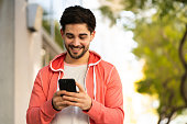 istock Young man using his mobile phone outdoors. 1311315085
