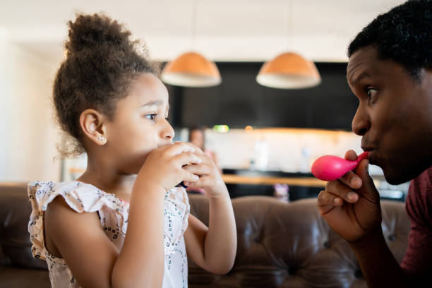 istock Daughter and father playing together at home. 1311315149