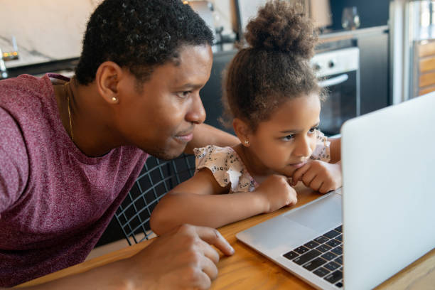 istock A father helping his daughter with homeschool. 1311315159