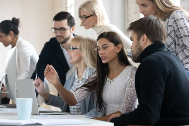 istock Multiracial colleagues work together collaborate at office meeting 1311315537