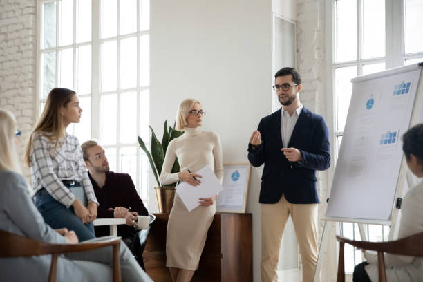 istock Male CEO present business project on whiteboard at meeting 1311315561