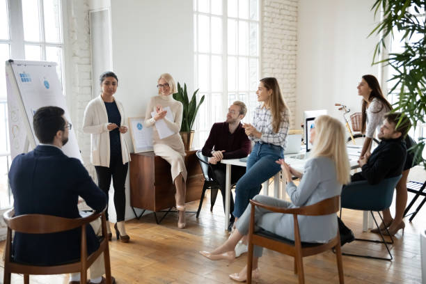 istock Indian female coach make whiteboard presentation for employees 1311315566