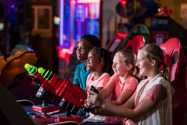 istock Four children playing amusement arcade game 1311317238