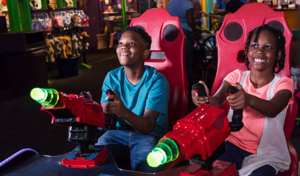 istock Boy and sister playing amusement arcade game 1311317338