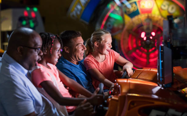 istock Two families playing an arcade game 1311317348