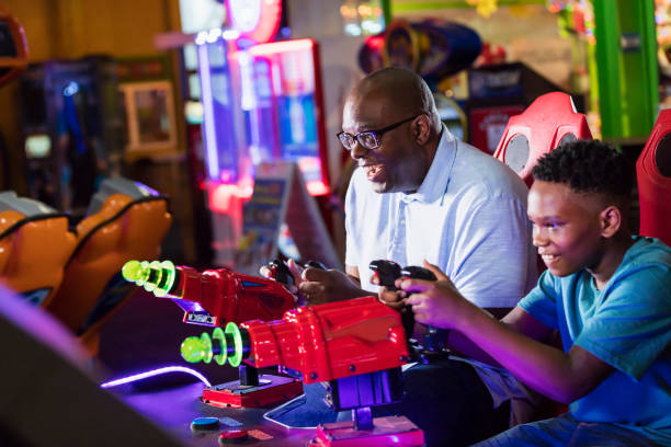 istock Father and son playing amusement arcade game 1311317487