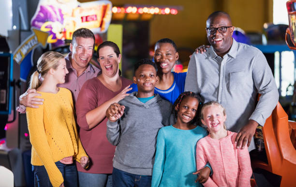istock Two families having fun at an amusement arcade 1311318044