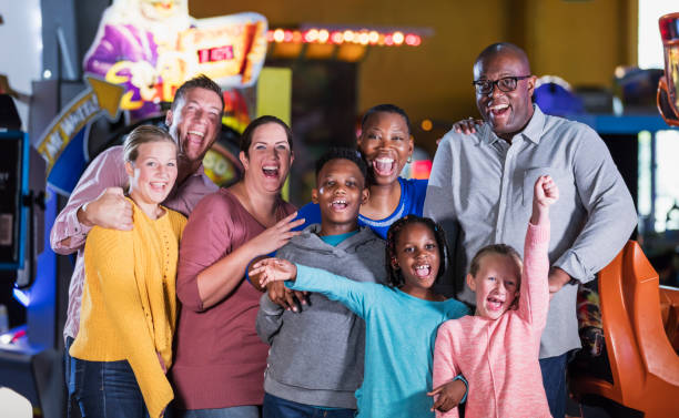 istock Two families having fun at an amusement arcade 1311318061